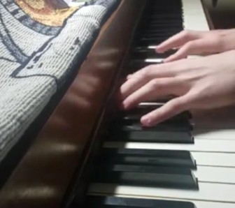 fingers on a piano keyboard